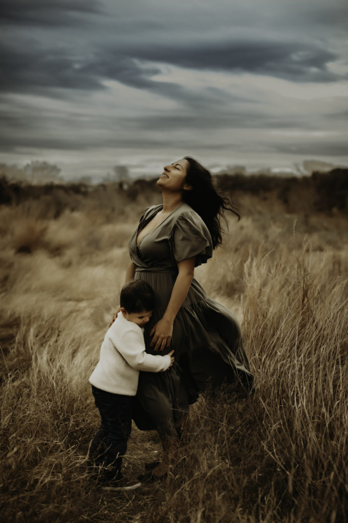 Mother standing in a field with her son in Austin, TX meredith mccann photography 